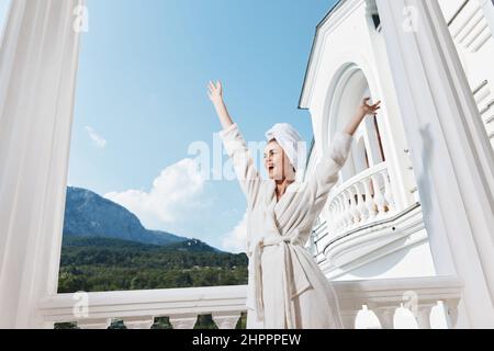 Portrait woman posing against the backdrop of mountains on the balcony architecture Perfect sunny morning Stock Photo