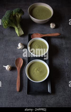 Healthy food ingredient fresh broccoli soup served on a dark background. Stock Photo