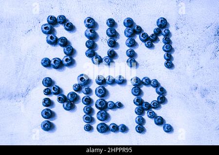 Summer inscription lined from blueberries. Fruits and berries, vegetarian and healthy eating concept. Summer text created from blueberries. Superfood Stock Photo