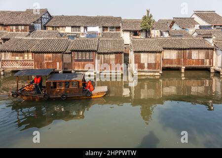 Tourist boat passing on a canal in the ancient water village of Wenzhou, China Stock Photo