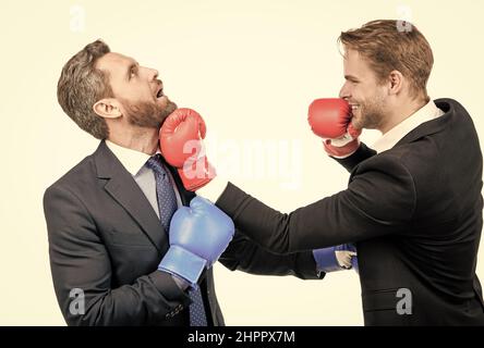 Business partners competitors fight with boxing gloves in formalwear isolated on white, competition Stock Photo
