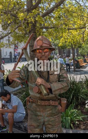 a mime disguised as a miner on a street in Santiago, Chile Stock Photo