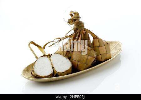 Ketupat, special dish served at Eid Mubarak or  Ied Fitr celebration in Indonesia. Ketupat is is a type of dumpling made from rice packed inside a dia Stock Photo