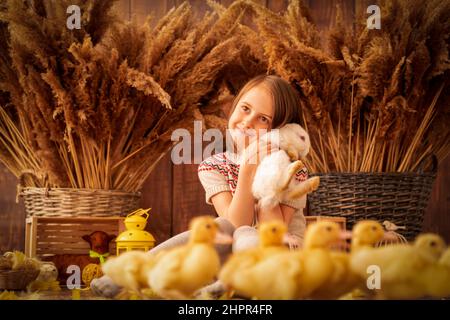 Easter portrait of hapy young beautiful girl with white rabbit. Horizontal image. Stock Photo