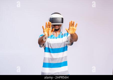 Handsome African man using VR glasses. Virtual reality experience. Stock Photo