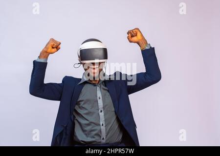 Handsome African man in a costume using VR glasses. Virtual reality experience. Stock Photo