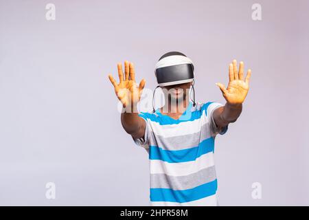 Handsome African man using VR glasses. Virtual reality experience. Stock Photo