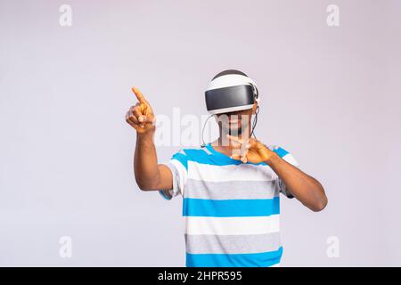 Handsome African man using VR glasses. Virtual reality experience. Stock Photo