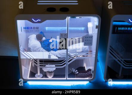 Beijing, China. 10th Feb, 2022. A man rests in sleeping and rest cabin at the main press center in Beijing during the 2022 Winter Olympics, China, February 10, 2022. Credit: Roman Vondrous/CTK Photo/Alamy Live News Stock Photo