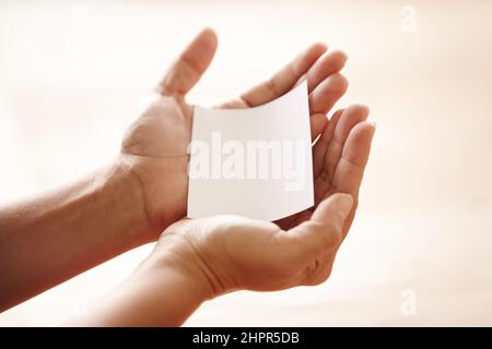 Taking your requests. Hands holding out a blank piece of copyspace like a request. Stock Photo