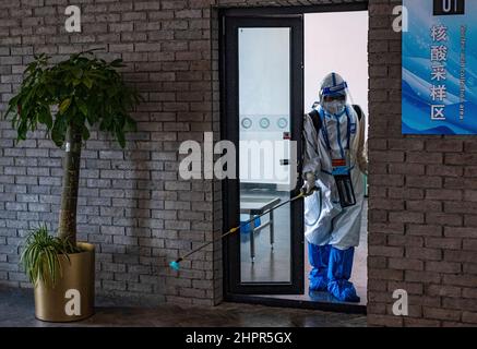 Zhangjiakou, China. 19th Feb, 2022. Worker in protective suits against COVID-19 disinfects the premises of the hotel resort in Zhangjiakou during the 2022 Winter Olympics, China, February 19, 2022. Credit: Roman Vondrous/CTK Photo/Alamy Live News Stock Photo