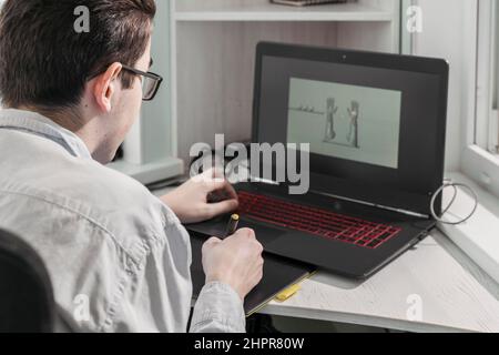 man creates video games. a designer creates a 3d model on his laptop Stock Photo