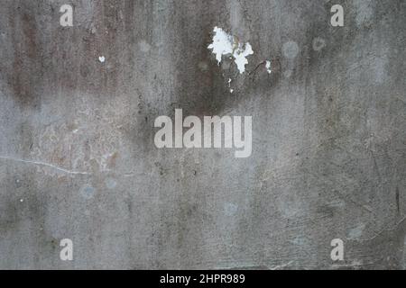 Old grunge dirty textured cement wall surface. With uneven stains and tiny holes. Stock Photo