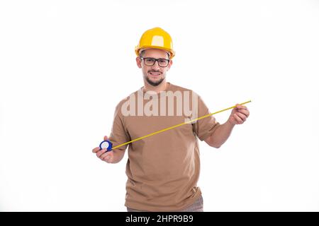 Construction Worker Checking Measuring Tape Isolated. Man Working, Looking to camera Stock Photo
