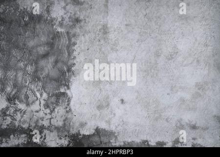 Old grunge dirty textured cement wall surface. With uneven stains and tiny holes. Stock Photo