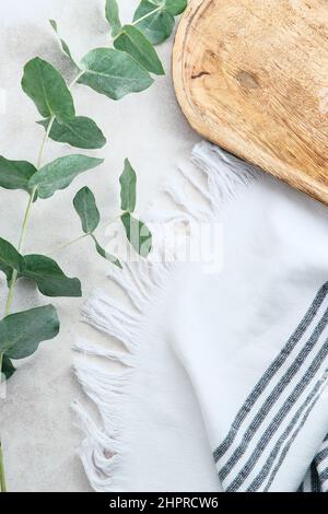 Bathroom stone table with eucalyptus branches, wooden board, towel. Cosmetic product placement concept. Stock Photo