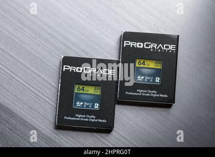 Two ProGrade SD cards, with packaging, on a silver background Stock Photo
