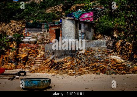 A small shack on top of the rocks next to the beach. Stock Photo