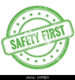 SAFETY FIRST text on green vintage grungy round rubber stamp. Stock Photo