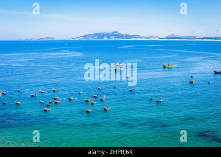 A group of round basket fishing boats moored overlooking an island off of Quy Nhon. Islands are seen far off. Stock Photo