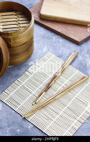 Sushi Roller mat on grey grainy background. Stock Photo