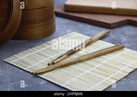 Sushi Roller mat on grey grainy background. Stock Photo