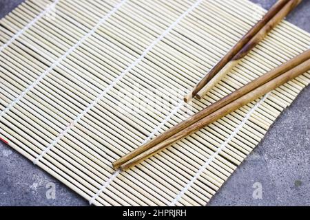 Sushi Roller mat on grey grainy background. Stock Photo