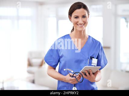 Healing with a little tech help. Cropped shot of a young female doctor holding a tablet. Stock Photo