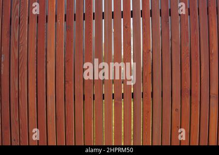 Wall texture of smooth dark brown natural wooden laths. Surface of wooden slatted screen for abstract background. Wooden slats shield. Stock Photo