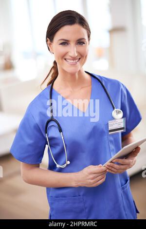 Healing with happiness. Portrait of a young female doctor in scrubs. Stock Photo
