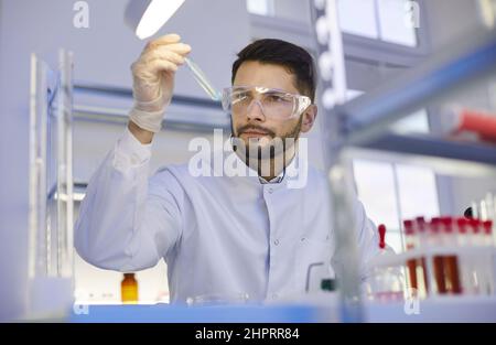Young man assistant do experiments in lab Stock Photo