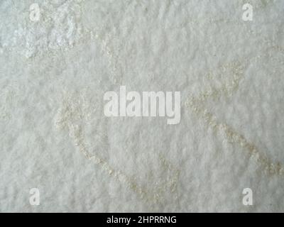 close up of blended white felt, handmade with wool of a sheep, with different colors white, natural white background Stock Photo