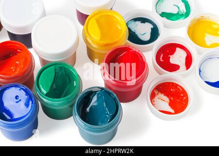 Multicolored gouache in plastic containers isolated on white Stock Photo