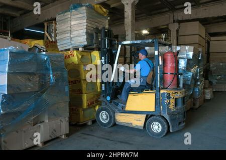 SAINT PETERSBURG, RUSSIA - AUGUST 10, 2021: A forklift truck works at a warehouse of construction materials Stock Photo