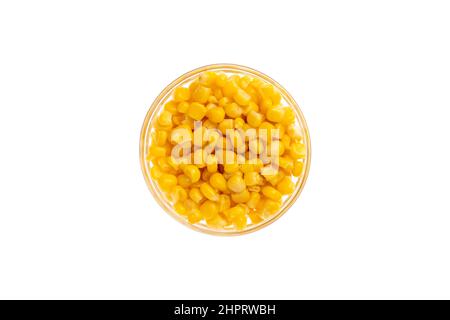 Canned corn seeds in a bowl isolated on white background, object from above, top view. Glass saucer Stock Photo