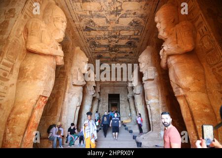 CAIRO, Feb. 23, 2022 (Xinhua) -- Tourists visit the Great Temple of Abu Simbel in Aswan, Egypt, Feb. 22, 2022. Abu Simbel temple complex consists of two massive rock-cut temples in southern Egyptian Aswan. On Feb. 22 and Oct. 22, the rays of the sun would reach and illuminate the sculptures on the back wall. (Xinhua/Sui Xiankai) Stock Photo