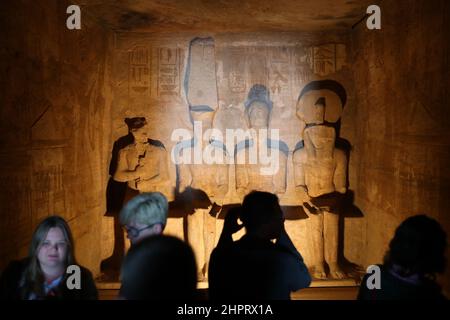 CAIRO, Feb. 23, 2022 (Xinhua) -- Tourists visit the Great Temple of Abu Simbel in Aswan, Egypt, Feb. 22, 2022. Abu Simbel temple complex consists of two massive rock-cut temples in southern Egyptian Aswan. On Feb. 22 and Oct. 22, the rays of the sun would reach and illuminate the sculptures on the back wall. (Xinhua/Sui Xiankai) Stock Photo