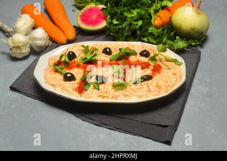 Carrot Tarator in Ceramic Plate. Traditional Appetizer. Ready to Eat and Serve. Traditional delicious Turkish foods; Fresh carrot salad with garlic yo Stock Photo