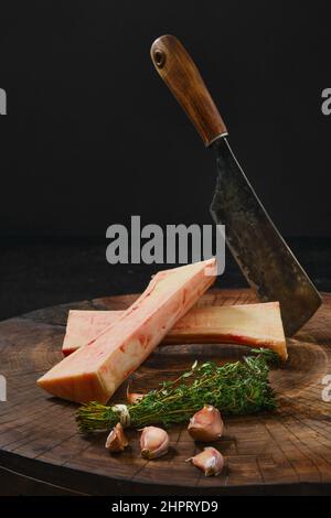 Raw beef bone marrow chopped on half on wooden stub Stock Photo