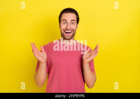 Photo of crazy positive amazed funky guy funky wow reaction wear pink t-shirt isolated yellow color background Stock Photo