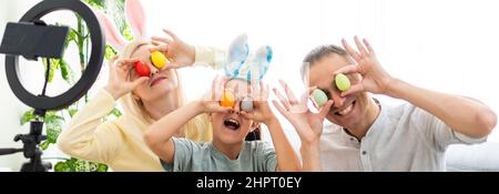 Father, mother and her child enjoy painting Easter eggs. Shop Online for happy easter decoration. Easter eggs - color egg assortment Stock Photo