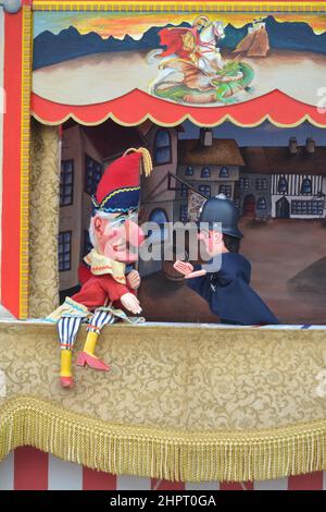 Punch + Judy Puppet Show - Punch Puppet - Policeman Puppet - Traditional Seaside Show - Family Fun - Years Gone By - UK Stock Photo