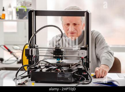 Man with 3D printer Stock Photo