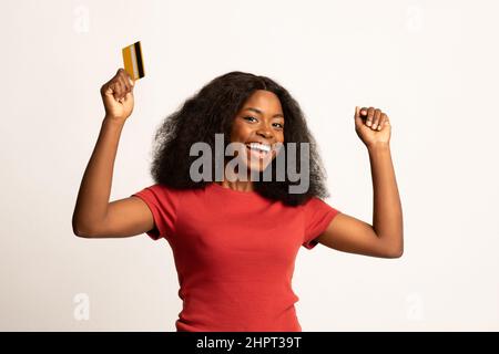 Easy Payments Concept. Excited Black Lady With Credit Card Celebrating Success Stock Photo