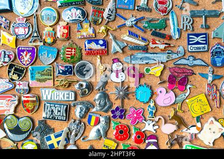 Colourful collection of pins from countries, cities, events on a cork board Stock Photo