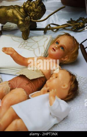 Old broken dolls at flea market. Child abuse concept.