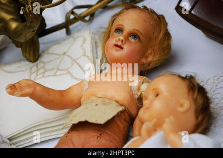 Old broken dolls at flea market. Child abuse concept.