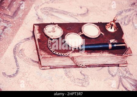 Old vintage diary book on marble table. Toned photo. Stock Photo
