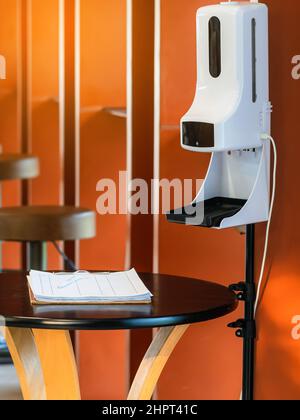 Stand automatic alcohol dispenser spraying with automatic body thermometer check temperature for covid-19 pandemic for safety before entering the coff Stock Photo