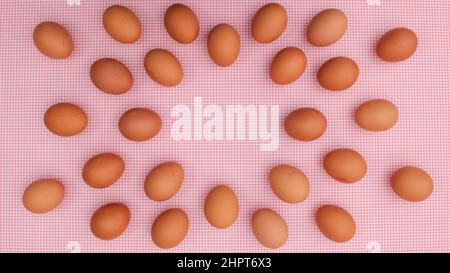 Fresh chicken eggs layout on pastel pink backgrund. Easter copy space flat lay Stock Photo